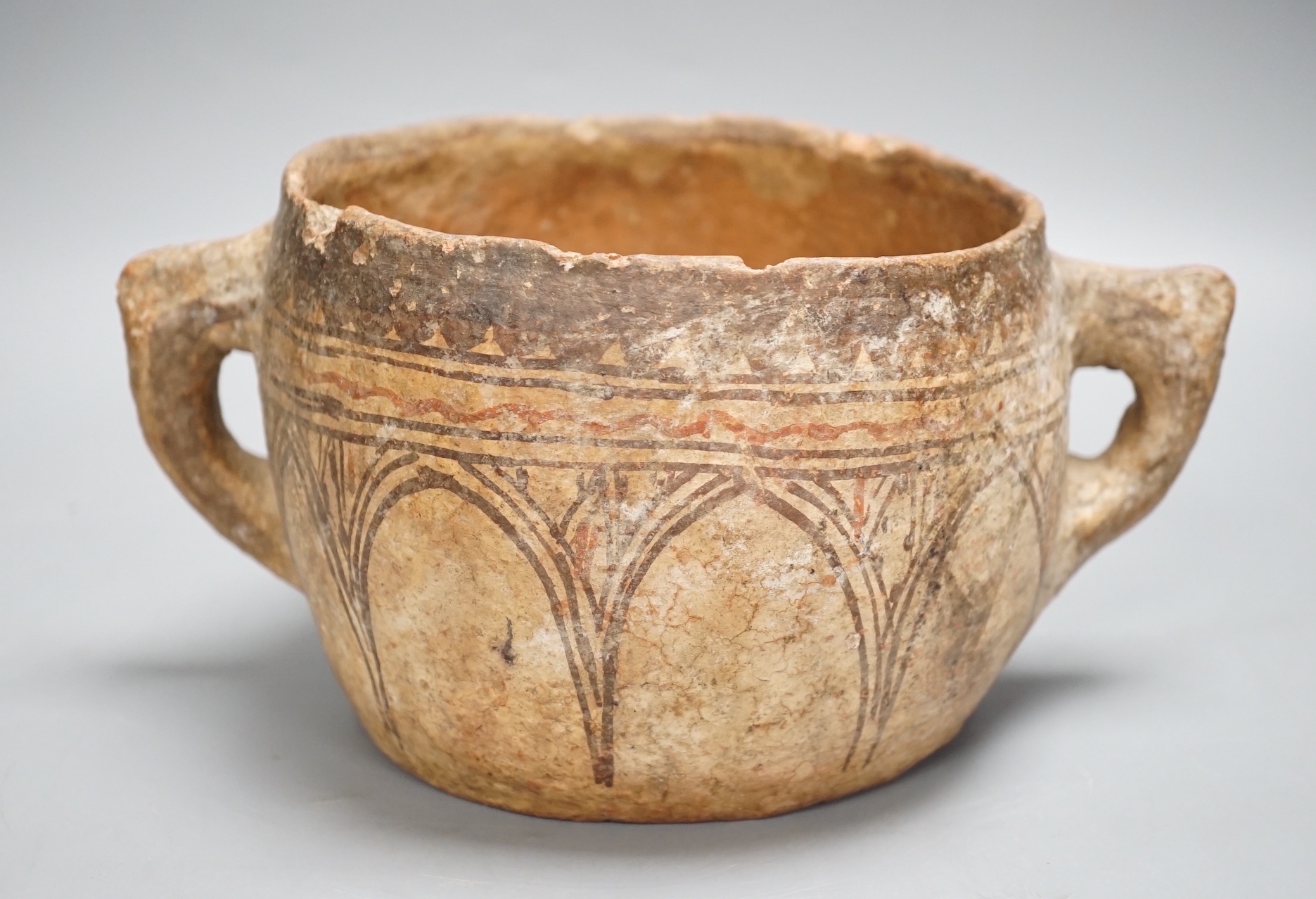 A pre-Columbian two handled terracotta vessel 25cm